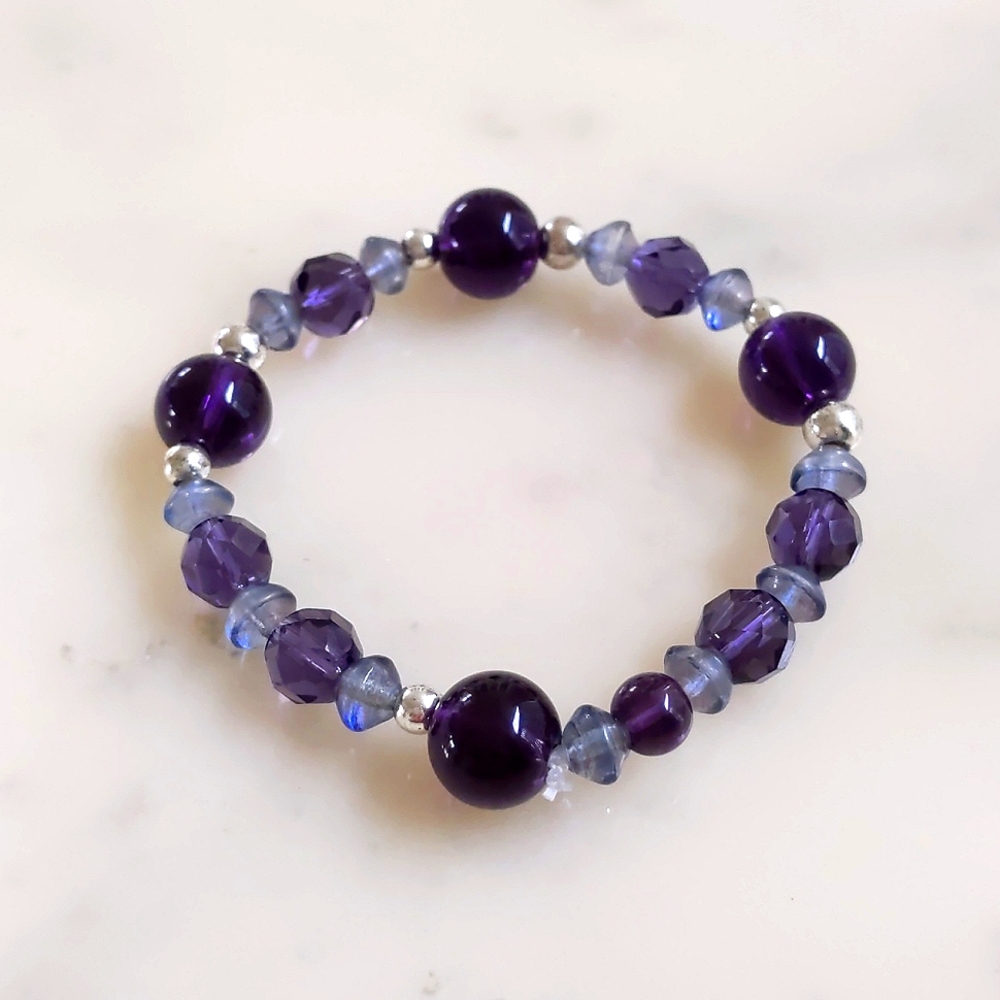 NWOT. The Limited Multi Shades of Purple/Shapes w/Chrome Beads Stretch Bracelet.